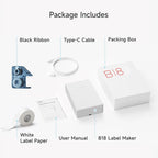 Contenu du coffret présenté à plat : imprimante, ruban carbone noir, câble USB-C, rouleau d'étiquettes et notice
