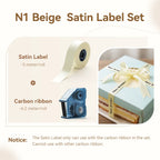 Coffret ruban satin beige de 5 m et cassette de ruban carbone, avec un cadeau noué d'un ruban Happy Birthday