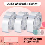 Trois rouleaux d'étiquettes transparentes 14 x 30 mm, 210 pièces par rouleau, un doigt visible au travers du modèle