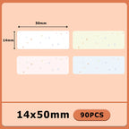 Quatre étiquettes pastel semées d'étoiles scintillantes, blanche, ivoire, rose et bleue, cotées 50 x 14 mm, 90 pièces