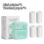 Imprimante vert menthe devant sa boîte, accompagnée de quatre rouleaux de papier thermique blanc